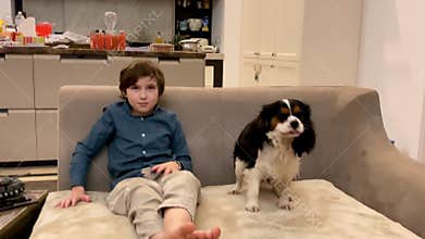 Behind the scenes portrait photoshoot of a boy with a dog