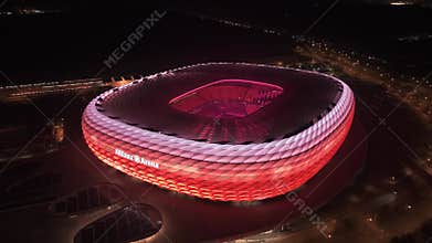 Drone night view of Allianz Arena Munich, Bavaria. Illuminated stadium exterior, famous football arena, Champions League