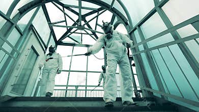 Sanitation workers clean pedestrian overpass to kill coronavirus.