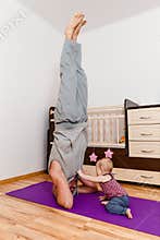 The man performs a rack on his head. sports daddy