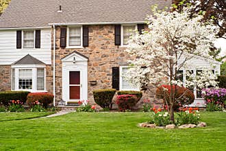 FAMILY HOUSE WITH FRONT LAWN IN SPRING