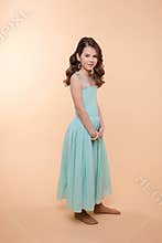 Cute little girl with curly hair smiling on camera