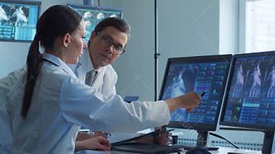 Medical doctors working in hospital office making computer research. Medicine, healthcare and technology concept.