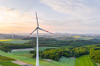 Wind wheels lush evening sun landscape