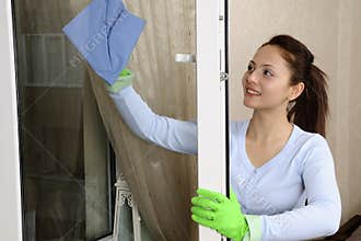 Beautiful women cleaning a window