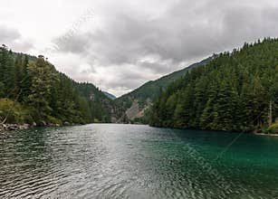 Beautiful mountain Lindeman lake green forest and cloudy sky british columbia canada