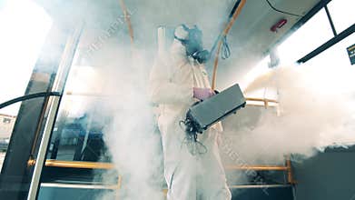 Bus is getting sterilized from inside by the inspector. Coronavirus, COVID-19 concept.