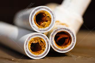 Sludge polypropylene plumbing pipes with rust and limescale. Corrosion and hard water concept. Rust broken water pipes