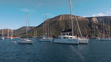 White catamarans and sailing yachts near seashore of Mediterranean sea. Lipari Islands, Sicily, Italy
