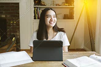 High School Student Learns from Home During Pandemic - Tablet Laptop - Home School - Living Room - Smiling Female