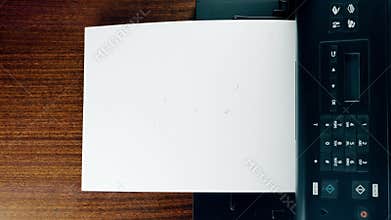 Office desktop laser printer printing single A4 letter page