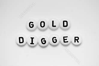 GOLD DIGGER written on white circles isolated on a white background
