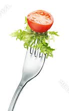 Tomato and lettuce on fork