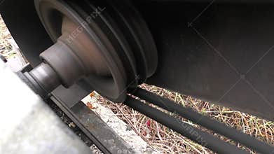 The electric motor rotates the shaft. Belt drive.