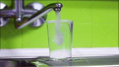 Glass of water filling to overflow