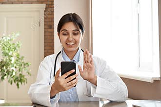 Smiling indian doctor video conference call patient in online mobile phone app.
