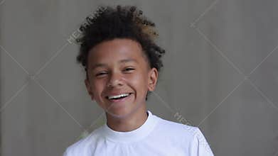 Portrait of African American boy is smiling and laughing in front of camera at home interior spbi.