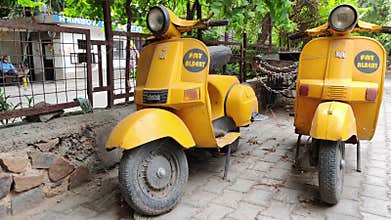 New Delhi, India. Fancy /quirky yellow colored Bajaj scooters parked used for food delivery by Fat Albert restaurant