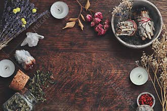 Dark brown wooden table background for text, decorated with witchy wiccan items to look esoteric and occult