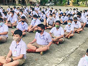 Trang, Thailand - July 31, 2020 : Students from Banyantakhao school wear surgical face mask to protect covid-19 and sit in row