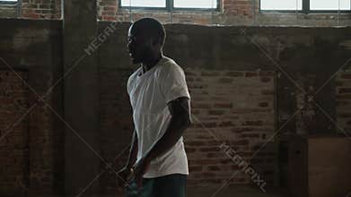 Black man having fun, doing dancing moves indoors