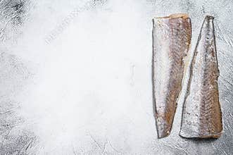 Raw fillet of hake fish. White background. Top view. Copy space