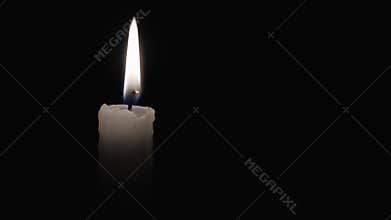 White candle on a black background