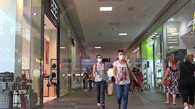 Portimao, Portugal - July 11, 2020: People shopping wearing protective face masks in Aqua Portimao shopping mall