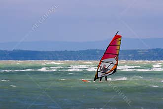 Surfer with red windsurf surrounded with waves - Lake Balaton