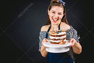 Pin-up styled woman presenting cake