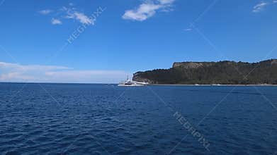 Luxury white yacht sailing in Mediterranean sea near mountains in Turkey