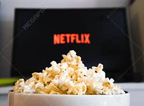 CHIANGMAI, THAILAND - JULY 5, 2019- Popcorn bowl and Netflix logo on Smart TV