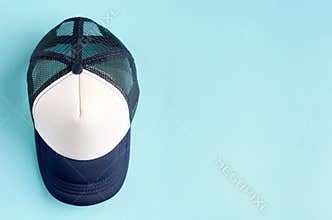 Baseball cap on blue background composition. Flat lay