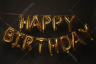 Phrase HAPPY BIRTHDAY made of golden balloon letters