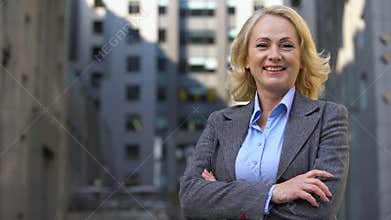 Smiling senior manager in business suit looking in camera, career motivation