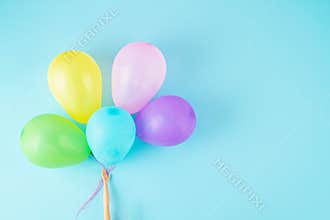 Doll hand holding colorful balloons. Party, celebration, childhood