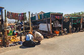 African woman with a tourist selling souvenir in her outdoor shop. Blyde river canyon, mpumalanga, South Africa