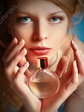 Girl with a bottle of perfume in her hands