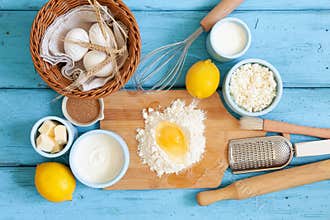 Frame of food ingredients for baking on a blue wooden background, cooking flat lay