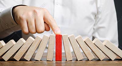 Businessman stops collapse domino effect. Stress resistance business. Financial stability. Recovery business. Evaluation of cash
