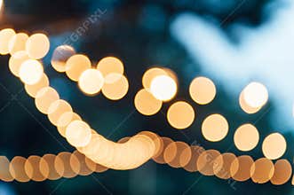 Light bulb decor in outdoor party. blurred photo