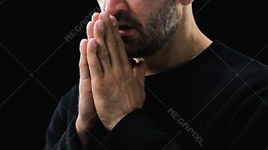 Sick poor man praying to God against dark background, Christianity, belief