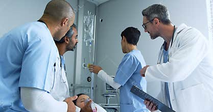 Group of doctors working together on a patient in hospital bed 4k