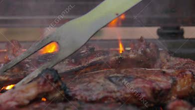Lamb steak flipped on the grill