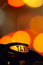 British london black taxi cab sign at night with c