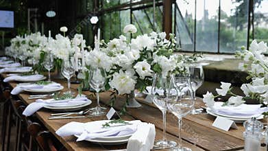 Decorating a Festive table. Wedding Table Decoration with Bouquets of Natural Fresh Flowers for a Family Feast