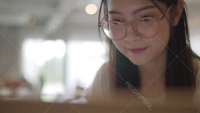 Freelance Asian women working on laptop at office. Young Asia business Girl using the computer for trade, send email, digital work