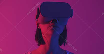 Woman in VR headset looking around.