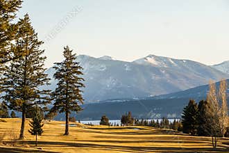 FAIRMONT HOT SPRINGS, CANADA - MARCH 22, 2019: Golf Course field in small town in rocky mountains sunny afternoon