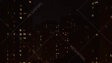 Static footage of thunderstorm showing close-up buildings in rainy night in city. Severe storm breaks over city lights